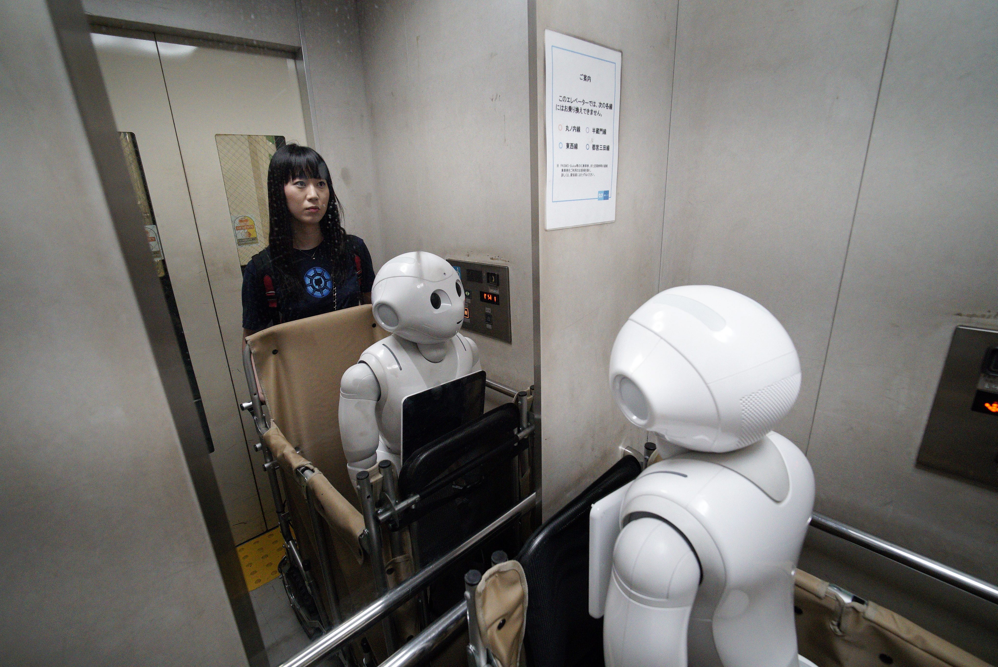 FRA47. Tokyo (Japan), 26/06/2016.- (16/21) Tomomi Ota and her humanoid robot Pepper in a elevator at a subway station in Tokyo, Japan, 27 June 2016. Reaching 120cm in height and 28 kilograms in weight, Pepper does not enter in the category of 'Äòportable'Äô robot. But those characteristics don'Äôt stop Tomomi Ota to take Pepper in a cart to stroll in her neighborhood, go shopping or even take the subway. In June 2014, when Pepper was presented for the first time by Japanese telecommunications and Internet corporation Softbank at a press event, Tomomi looked at the presentation via a live broadcast on Ustream. While some people were 'Äòscared'Äô or reluctant by the new humanoid robot, curiosity pushed her to apply to lottery sales for the first lot of 200 Pepper. She was lucky enough to acquire then a 'ÄòDeveloper'Äôs Pepper'Äô, the first models of the robots which need to be programmed by the users. Pepper entered Tomomi'Äôs home in November 2014 and was soon adopted by her parents to become a member of the family. Having degrees in media design and music, Tomomi had to learn programming and her efforts deepened her bonds with her new friend. Capable of reading human emotions and to adapt to his interlocutor, the robot created by Aldebaran Robotics and SoftBank Robotics is now used as customer service in stores and 1000 units are sold out in minutes after being on sale every month. Pepper is making his way to Japanese homes but few can enjoy so much outdoor like Tomomi'Äôs one. Asked if she isn'Äôt worried about damaging her robot friend during her activities, the 30-year-old said that she is taking extra care as she couldn'Äôt imagine being separated two months from Pepper, the average time needed for a repair. (Tokio, Japón) EFE/EPA/FRANCK ROBICHON PLEASE REFER TO THE ADVISORY NOTICE (epa05406529) FOR FULL PACKAGE TEXT